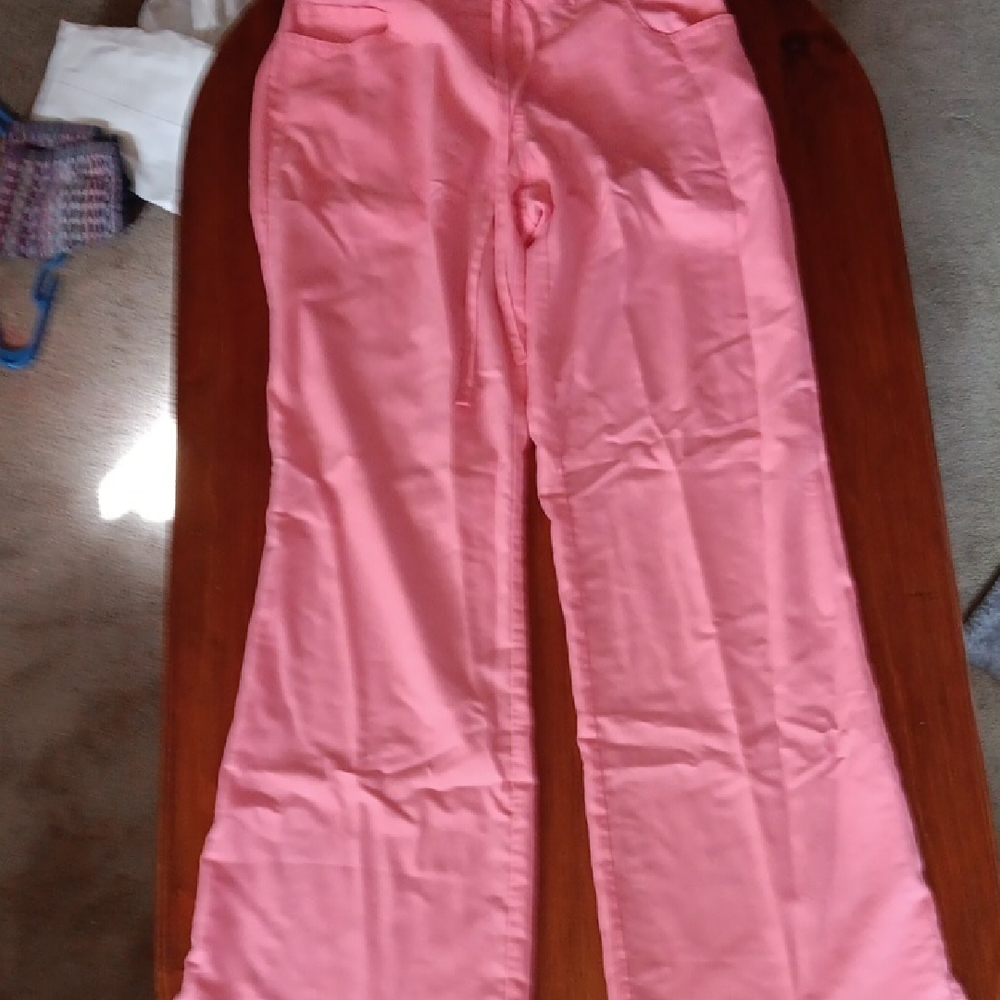Peach/ coral flared womans scrubs. No tag but fit like a medium.  Good used cond